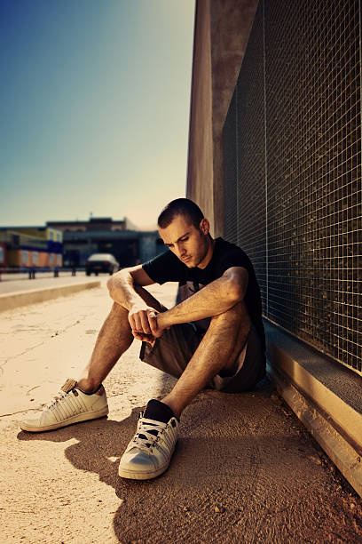 istock Young Man Sitting on Street 108176453