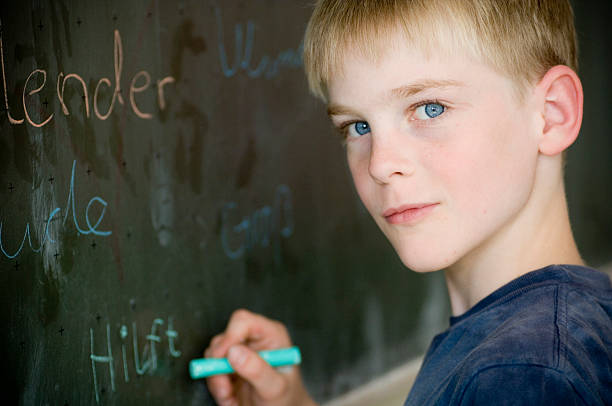 istock Portrait of Little Boy Writing on Chalkboard 108176550