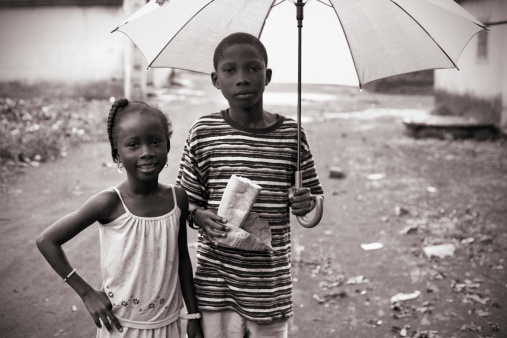 african kids out in rainy day.