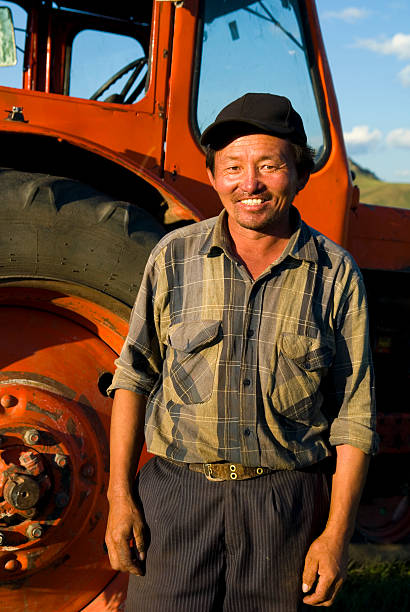 istock Asian Farmer Standing Beside Tractor 108176698