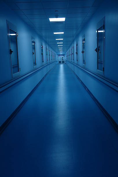 istock Long and Dark Blue Hospital Hallway 108176734