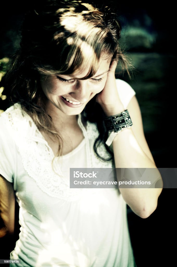 Portrait of Young Woman Smiling, Low Key  Adult Stock Photo