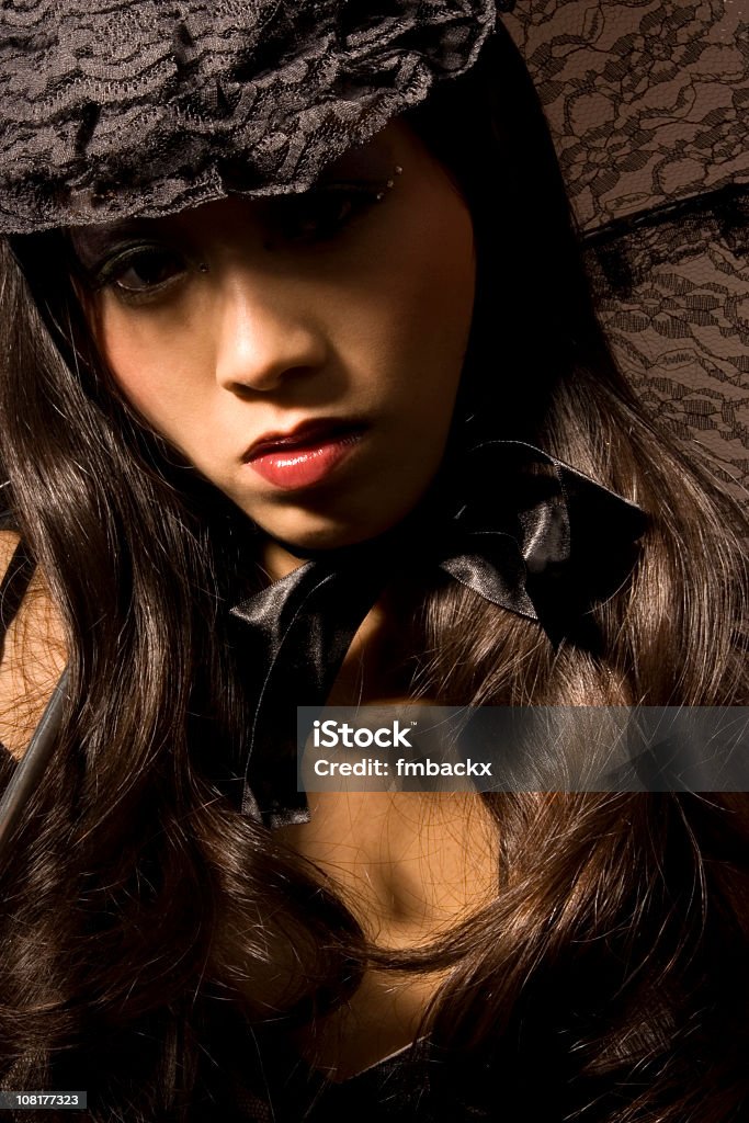 Fashion portrait Fashion picture of a beautiful Asian woman wearing a lace hat. Adult Stock Photo