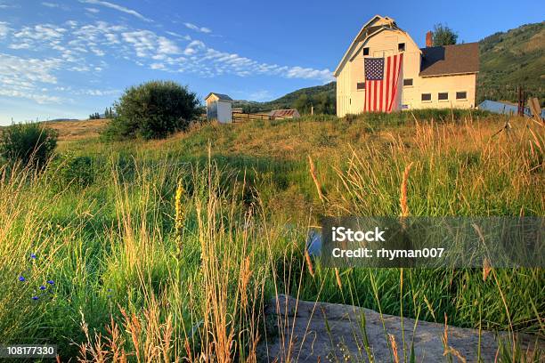 American Farm With Giant Flag In Field Stock Photo - Download Image Now - Barn, American Flag, Farm
