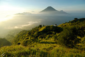 Misty mountain and volcano landscape in Indonesia at sunrise