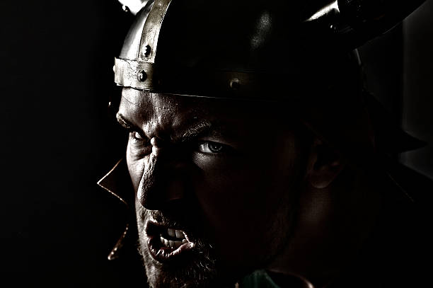 Bloody muscular torso and helmet of gladiator.