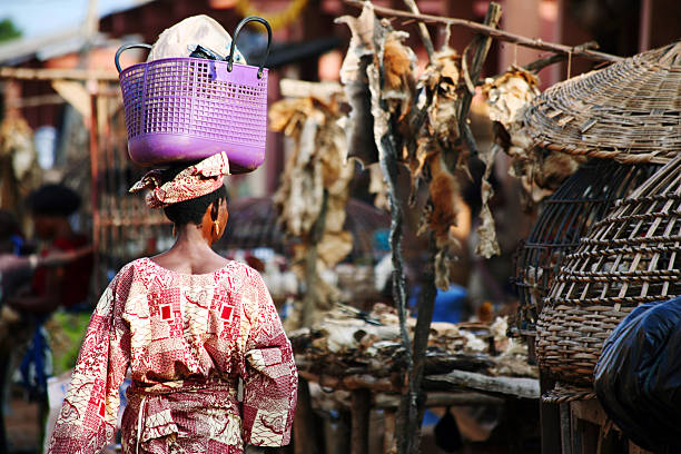 African Woman Walking Through Market calavi, benin. benin stock pictures, royalty-free photos & images