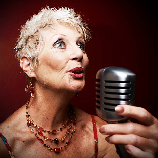 istock Senior Woman Singing Into Retro Jazz Microphone 108177510