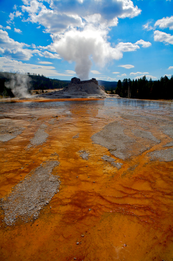 Scenic view of Porcelain Basin Hot Springs thermal area at Yellowstone National Park. Visitors walk along a boardwalk.