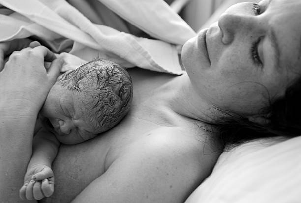 istock Newborn Baby Lying on Mother, Black and White 108178114