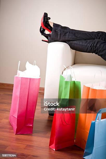 Foto de Mulher Relaxando No Sofá Depois De Compras e mais fotos de stock de Sofá - Sofá, Bolsa - Objeto manufaturado, Relaxamento