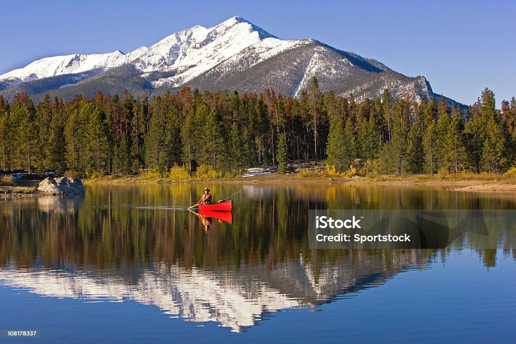 Fly Fishing On A Colorado Lake. Photo of a man fly fishing and canoeing on Lake Dillon in Summit County, Colorado. Colorado Stock Photo