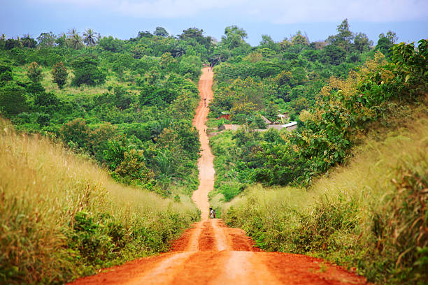 Rural Red Dirt Road in African Countryside near ouidah, benin. west africa stock pictures, royalty-free photos & images