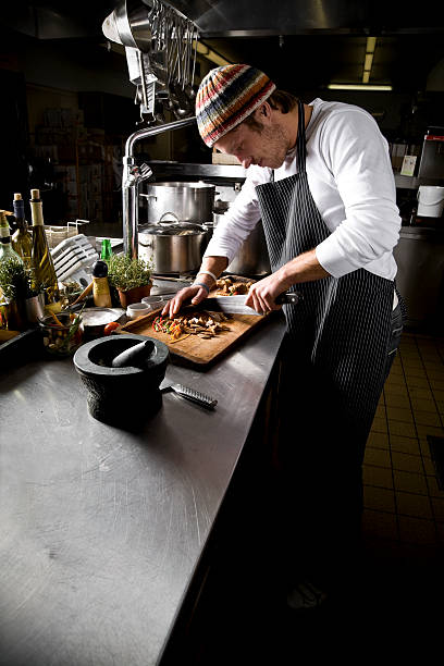 istock Male chef cutting vegetables on a restaurant kitchen counter 108178548