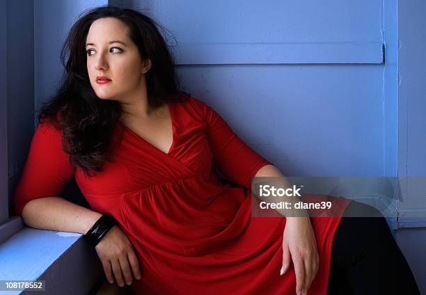 Portrait Of Voluptuous Woman Wearing Red Dress And Posing Stock Photo - Download Image Now