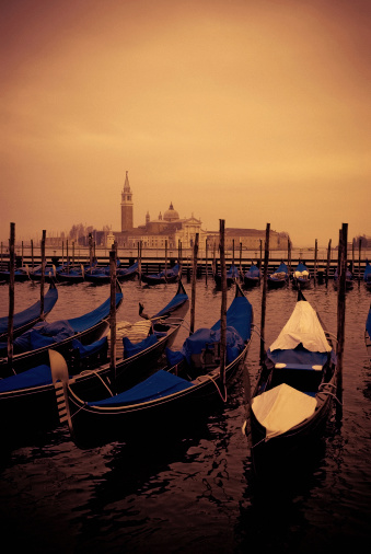 sunset at the grand canal in venice, gondolas moored