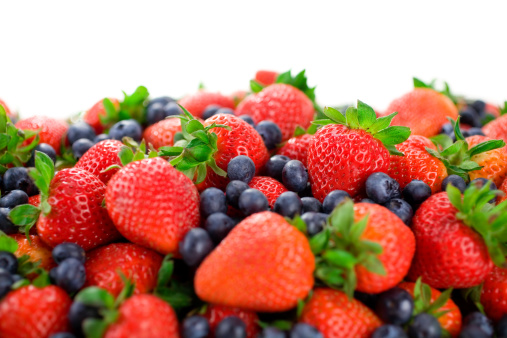 Plenty of berries with leaves floating in air on white background. File contains clipping paths.