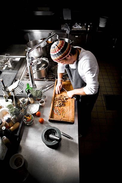 istock Chef Cutting Figs on Wooden Chopping Board in Restaurant Kitchen 108178742