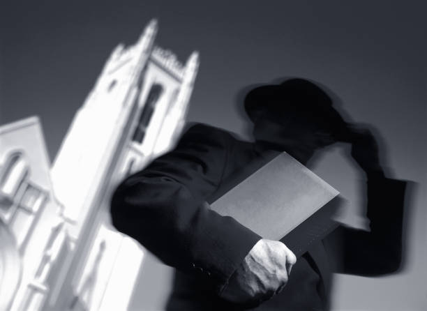 Priest Man Carrying Book and Leaving Church stock photo