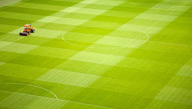 istock Lawn Mower Vehicle on Soccer Stadium Playing Field 108179054