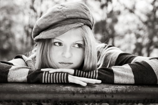 Beautiful blonde girl wearing a corduroy cap (light sepia).