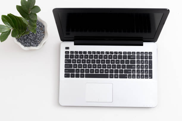 istock White office desk with laptop office plant and notebook 1081796700