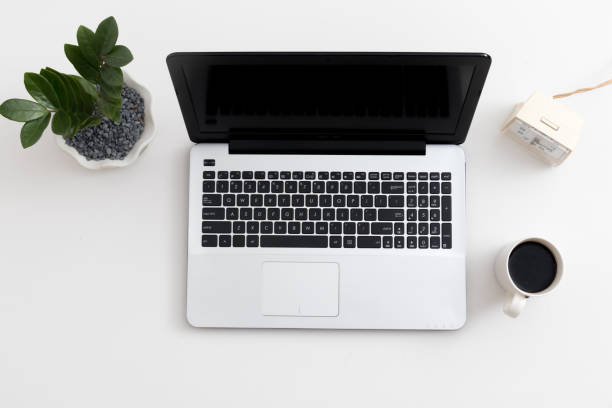 istock White office desk with laptop office plant and notebook 1081796904