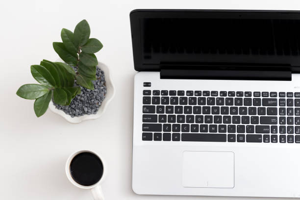 istock White office desk with laptop office plant and notebook 1081798090