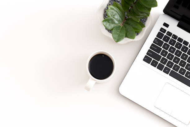 istock White office desk with laptop office plant 1081798558