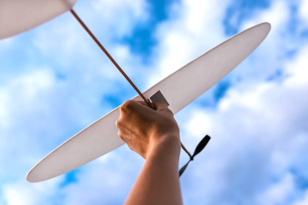 istock Toy plane in woman's hand in sky. 1081799814