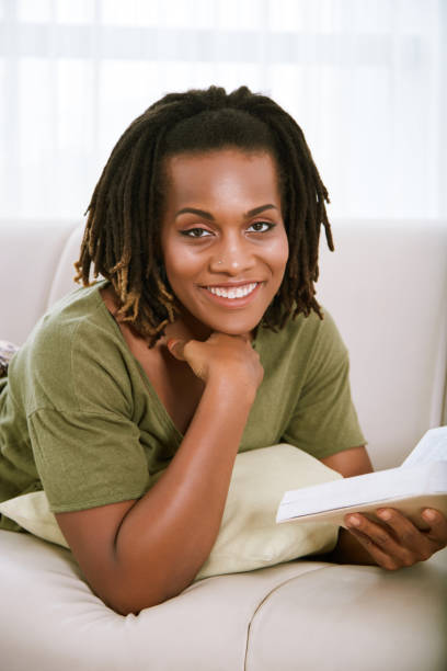 istock Smiling woman resting with book 1081805424
