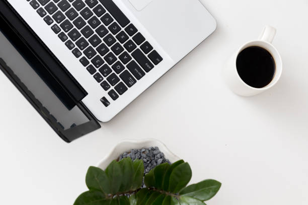 istock White office desk with laptop office plant and notebook 1081805548