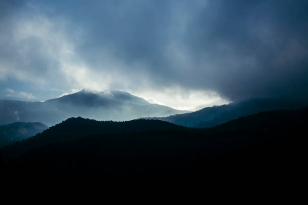 istock Sun shining on a blue landscape over the mountains 1081824128