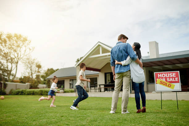 I think the kids love it here Shot of a family of four viewing their new home house for sale by owner stock pictures, royalty-free photos & images