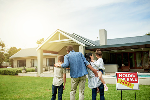 Shot of a family of four viewing their new home together