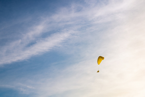 Silhouette picture of the Paramotor Flying through sunlight Sky Sunset,Freedom conept,copy space. - Image