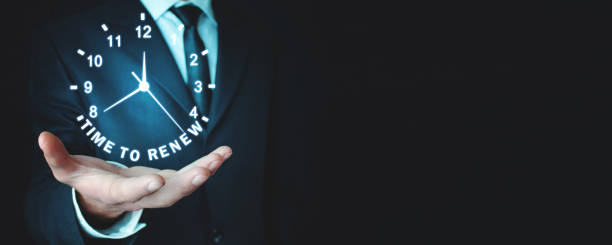istock Man holding clock. Time To Renew 1081825224
