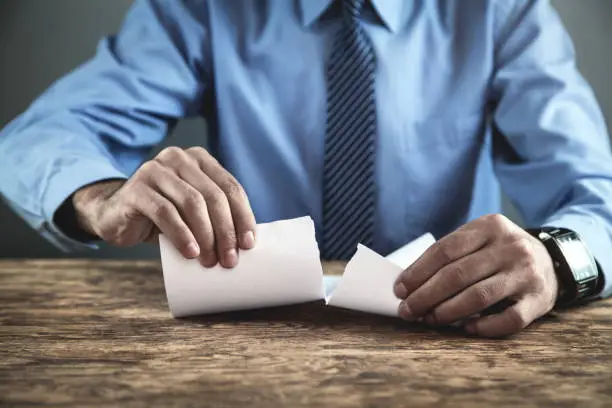 Photo of Businessman tearing contract.