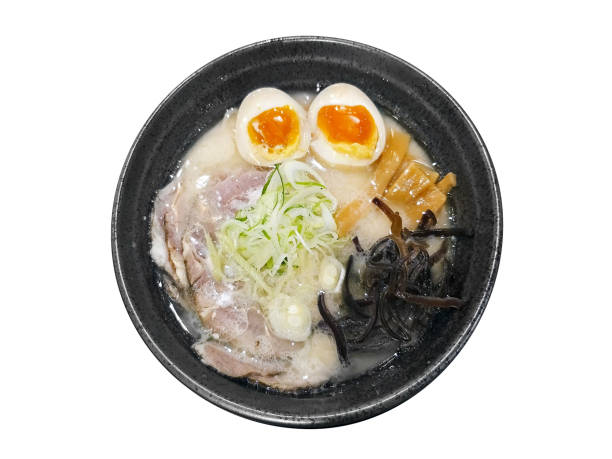 traditional Tonkotsu Ramen japanese noodle served on black stone bowl isolated on white background stock photo