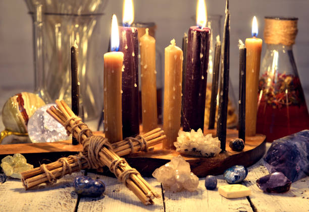 istock Burning candles, old bottles and flasks, crystals and cross on table 1081828232