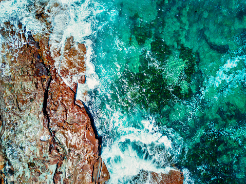 Aerial topdown viewws of ocean and rocks Durras, Australia