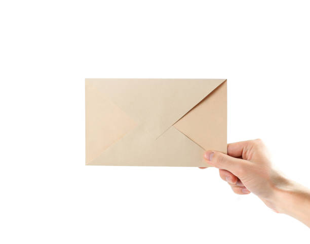 istock The hand holding the envelope. Close up. Isolated on white background 1081846884