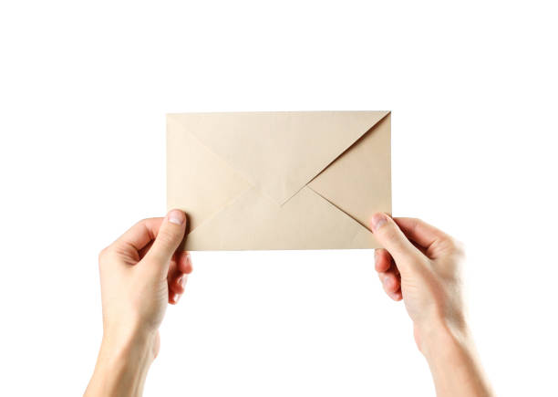 istock The hand holding the envelope. Close up. Isolated on white background 1081846914