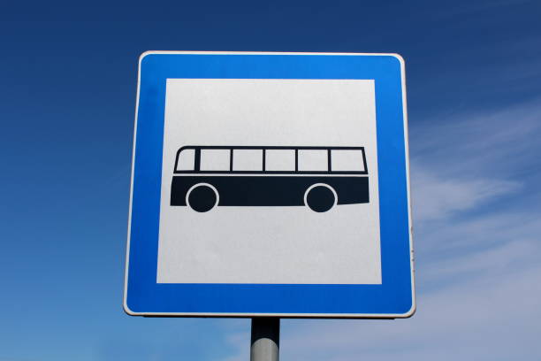 istock Bus station rectangular metal sign with blue frame and black bus mounted on grey metal pole 1081848714