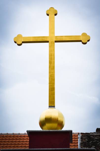 istock golden cross close up on blue sky 1081849108
