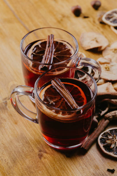 istock Mulled wine in mugs with scarf on wooden table 1081854018