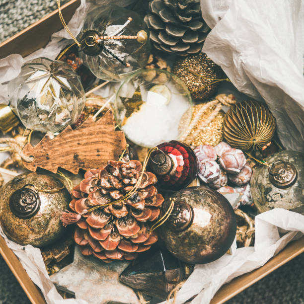 istock Christmas tree decoration toys and cones in box, square crop 1081854426