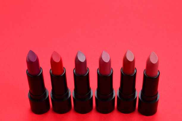 istock Many different lipsticks, different colors on lilac background. Space for text or design. 1081856936
