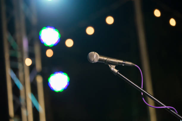 istock microphone in concert hall or conference room soft and blur style for background. 1081860070