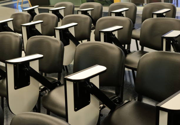 istock closeup of empty lecture chairs 1081863896